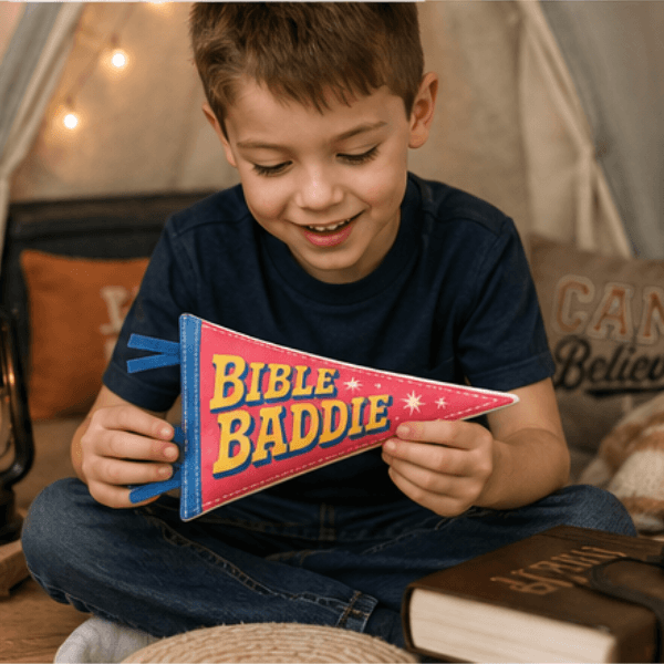 Child holding finished Bible Baddie pennant, Holy Smoak Studios Camp Believers wholesale faith-based product