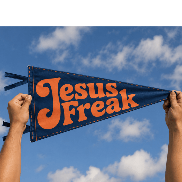 Hands holding finished Jesus Freak pennant against blue sky, Holy Smoak Studios Camp Believers wholesale faith-based product