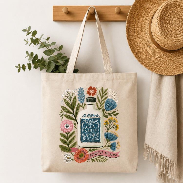 Agua Santa Canvas Tote Bag lifestyle shot of bag hanging on a hook, Holy Smoak Studios wholesale Christian gift shop tote bag