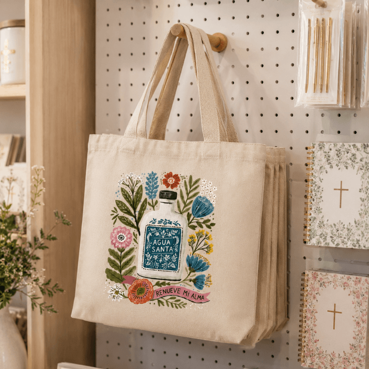 Holy Smoak Studios Agua Santa Canvas Tote Bag in retail display, wholesale Catholic gift shop tote
