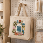 Holy Smoak Studios Agua Santa Canvas Tote Bag in retail display, wholesale Catholic gift shop tote